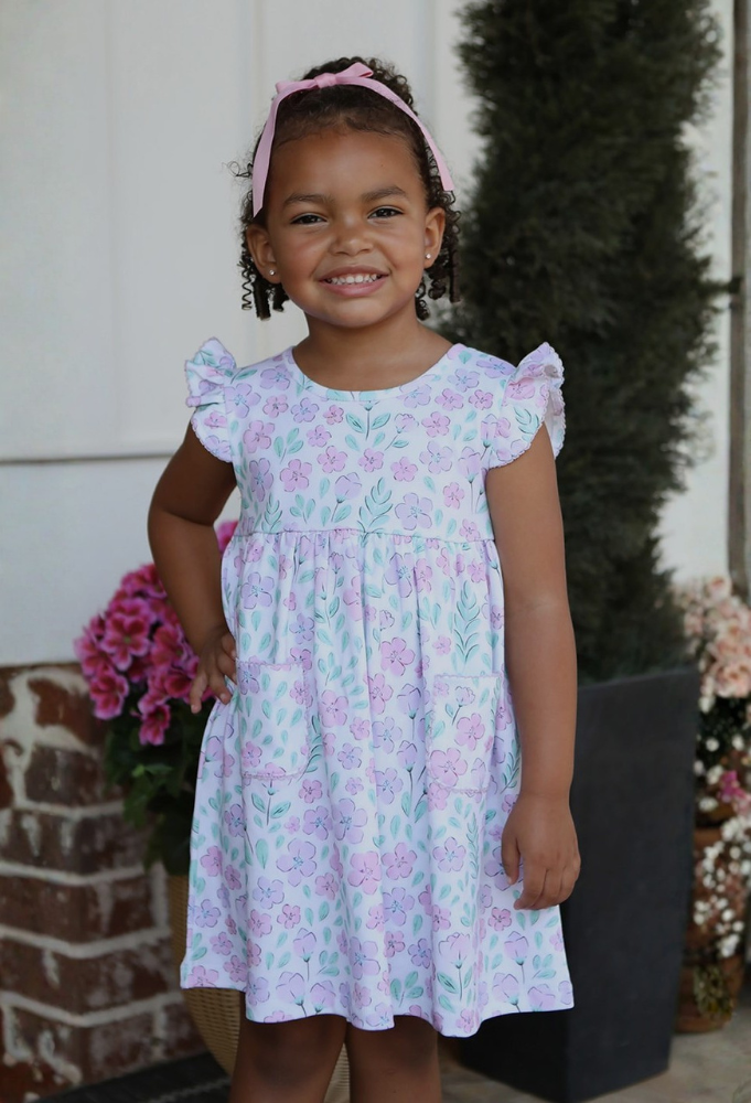 Three Sisters Market Dates Young girl in a cute summer dress with flowers and ruffled capped sleaves